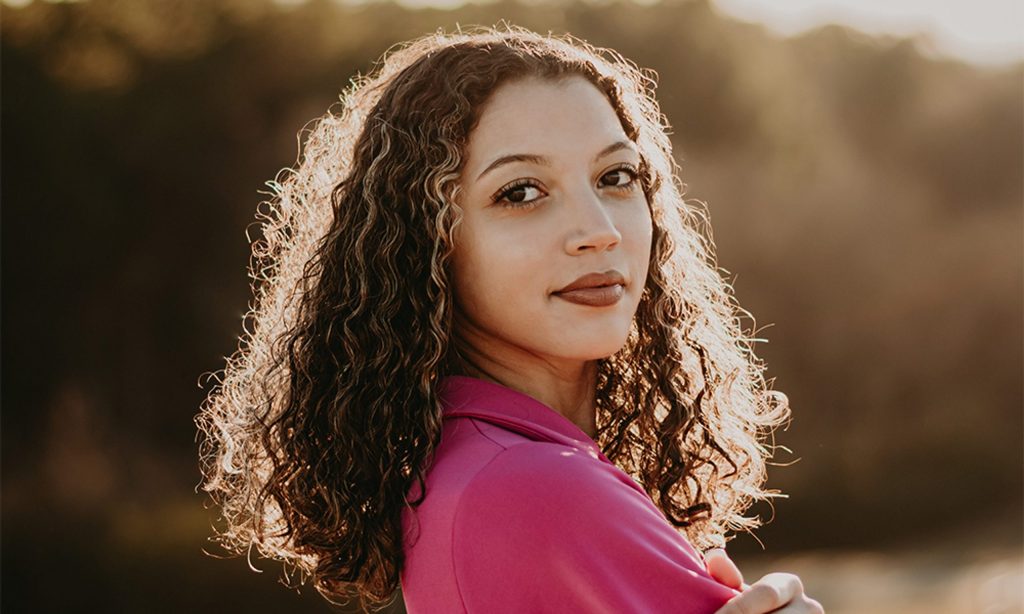 Young woman near Aurora, IL experiencing common symptoms of pregnancy.